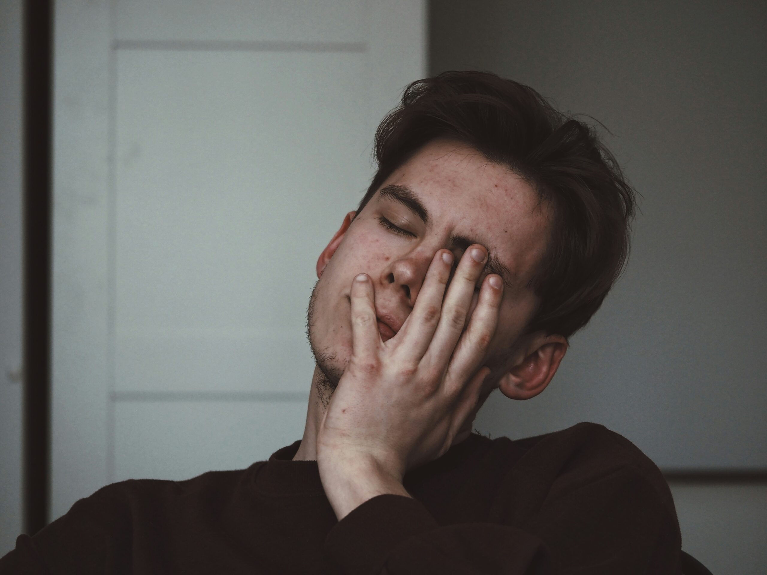 a man with his hand on his face